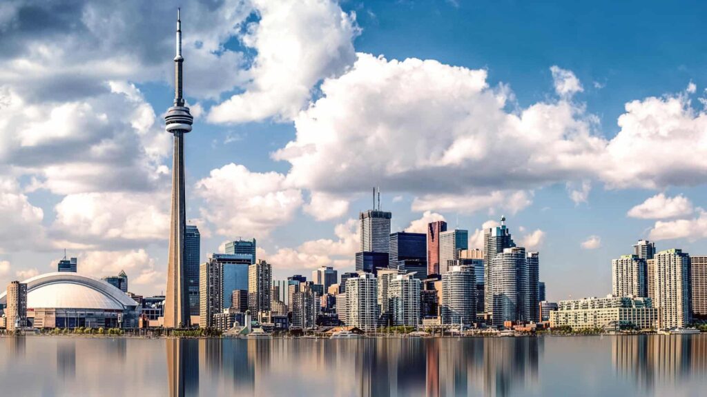 Tourist places in Canada featuring the CN Tower in Toronto skyline at sunset